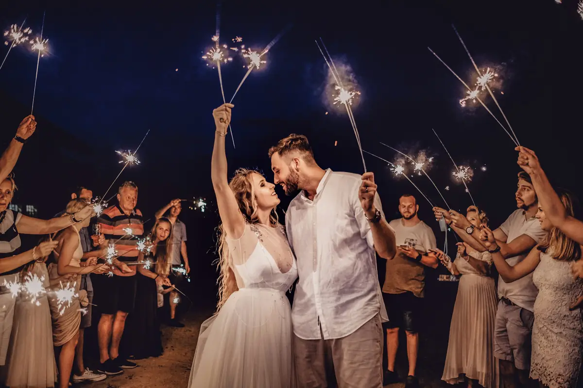 Couple walking through a tunnel of sparklers at night